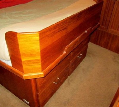 four drawers under berth, custom wood bolster at foot of bed