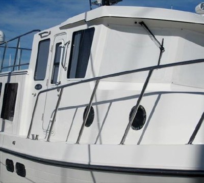 lots of opening port lights, windows, and doors each side of pilothouse