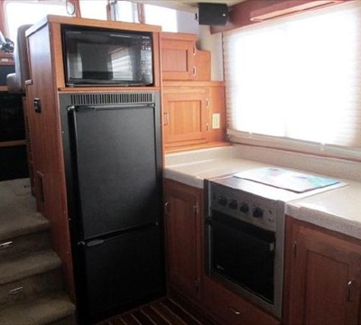 galley looking forward, fridge/freezer, microwave & electric stove with oven