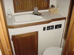 Molded sink / vacu-flush toilet